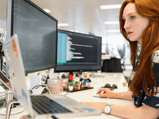 Red hair woman with computers